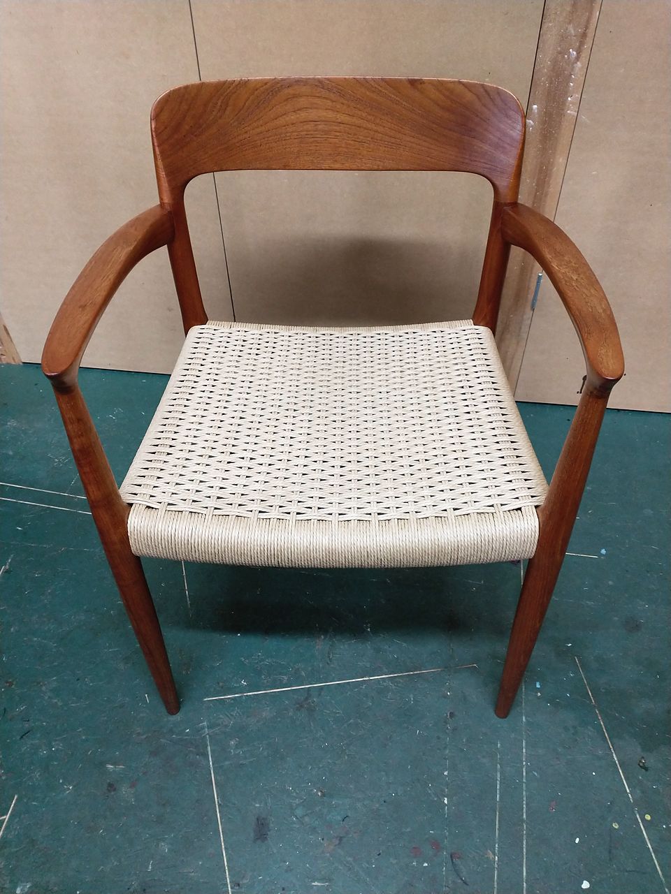 The same mid-century armchair after, with its paper cord seat rewoven