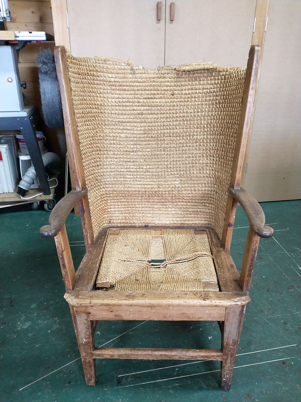 Orkney-style chair with a woven straw back, before restoration, with the seat worn through