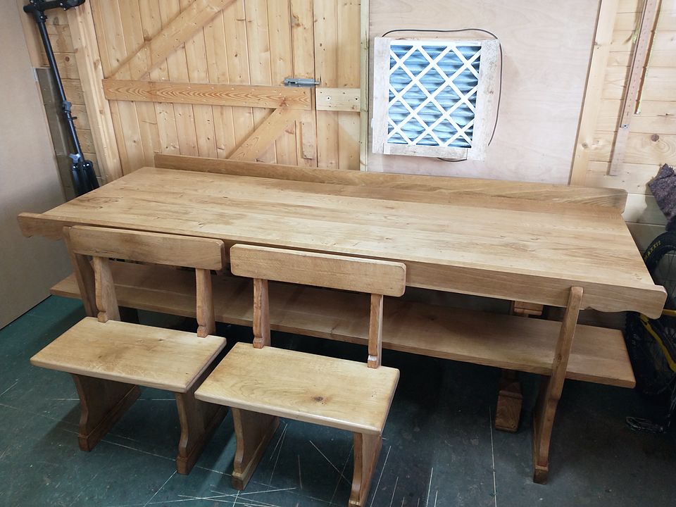 Solid-wood refectory table with two matching benches with backs, in the workshop